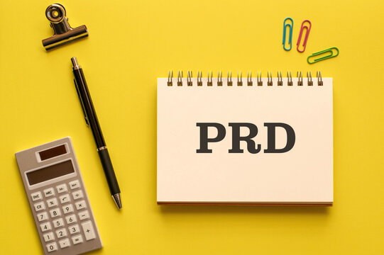 There is notebook with the word PRD. It is an abbreviation for Product Requirements Document as eye-catching image.