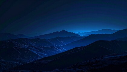 Dark mountain range under a night sky with moonlit peaks.