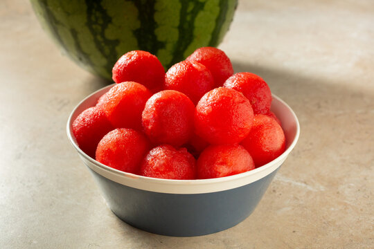 A view of a bowl of watermelon balls.