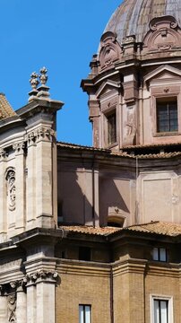 sunlit ornate baroque church weathered stone dome sculpted facade layered architecture stands against vivid blue sky rome view italy roman empire emperor fa ade details 