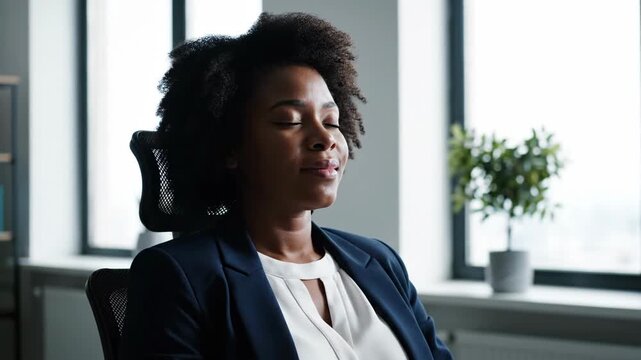Serene professional Black woman taking a mindful pause in a modern office, cultivating inner calm and promoting mental well-being during a busy workday