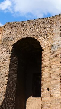ancient roman brickwork tall arched openings layered stone and brick walls weathered masonry contrasts bright blue sky domus augustana up close view rome italy empire emperor 
