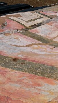weathered roman marble floor mosaic large stone slabs arranged geometric patterns partial restoration protective borders appear domus augustana rome italy empire emperor surface 