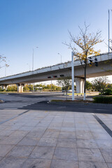 Concrete structure and asphalt road space under the overpass in the city