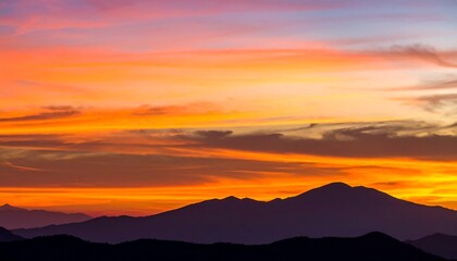 Obraz premium Colorful sunrise or sunset over a mountain range