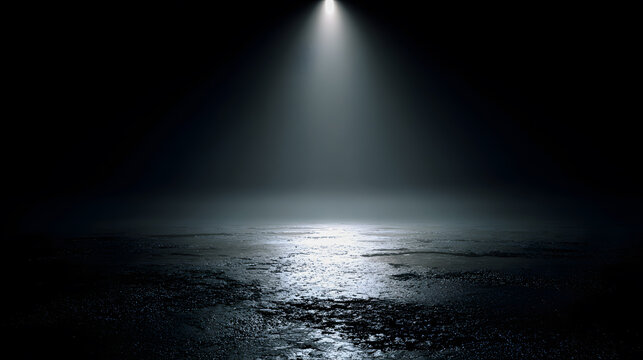 Dramatic spotlight shining on wet asphalt in dark mysterious environment
