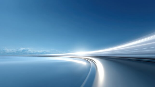 Smooth winding road with motion blur against a vibrant blue sky showcasing tranquility and speed in a serene landscape