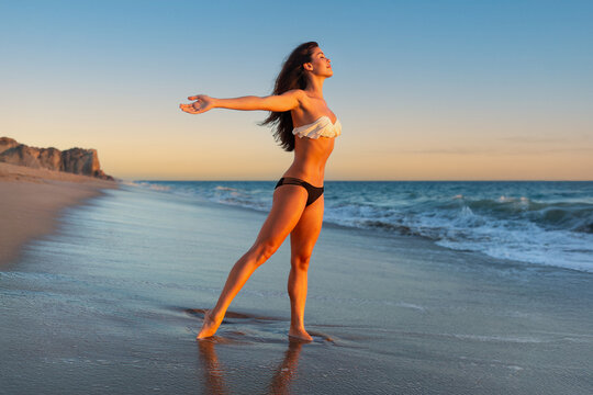 Beautiful Multiethnic Model Embracing Freedom, Arms Stretched Out In Hawaiian Tropical Beach Swimsuit
