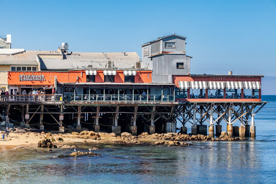 The Fish Hopper restaurant on stilts over ocean in Monterey California coastal tourist area