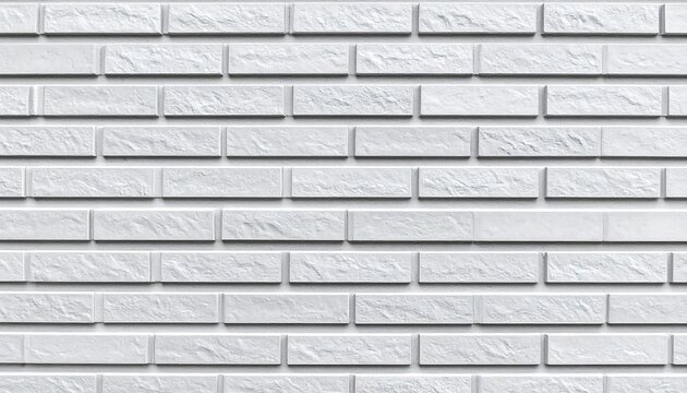 A close-up shot of a white brick wall, evenly stacked with slight texture on each brick and dark grout lines