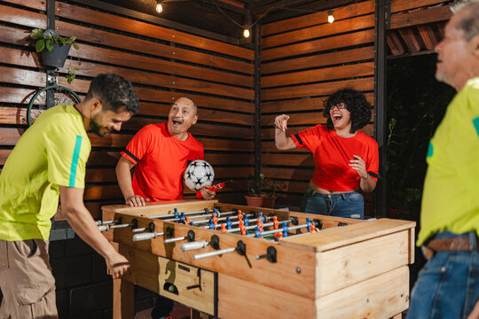 red team teammates mocking their opponent after a dominant foosball play