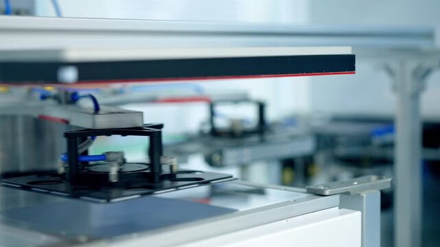 Close-up of Automated Robotic Arms Handling Silicon Wafers on High-Tech Production Line