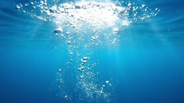 Underwater Bubbles Rising To Surface, Sunlight Rays Shining Through Clear Blue Water