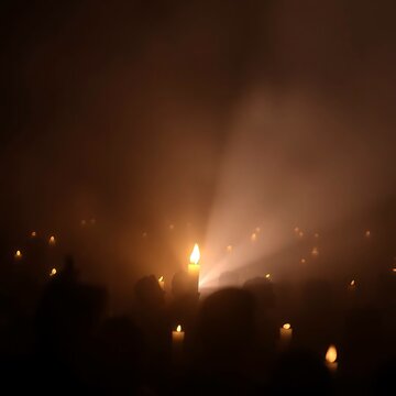 Solitary flame amidst a candlelight vigil. Use it for holiday, memorial, vigils