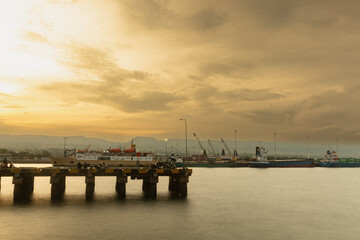 Fototapeta premium A solemn atmosphere settles as evening descends near Waingapu harbor, after nearly three days of being battered by a storm resulting from the incipient tropical cyclone 