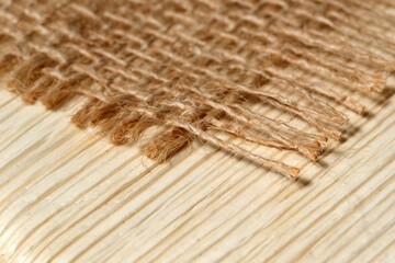 Close-up view of natural fibers on a wooden surface in soft light