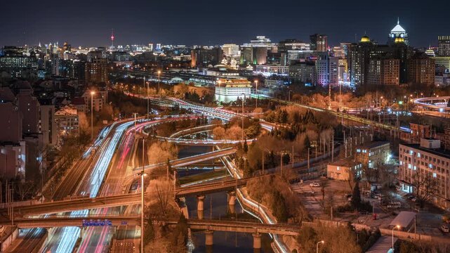 Night time-lapse of traffic flow at Dongbianmen Bridge and the moat in Beijing, China