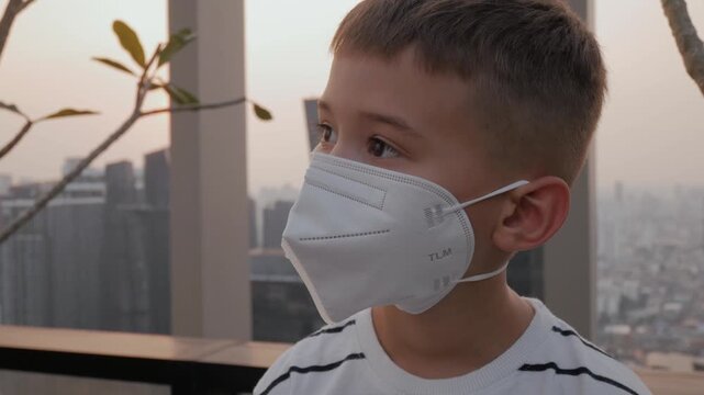 Boy wearing protective mask. Child health safety and air pollution awareness concept