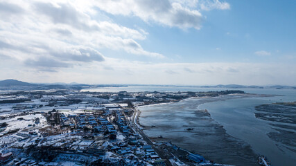 Obraz premium Aerial view of Jupo Hanok Village and Hampyeong Bay tidal flat in winter snow, South Korea