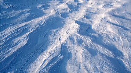 Fototapeta premium Snow-Covered Landscape: An aerial perspective captures the abstract beauty of a snow-laden landscape. The pristine white surface, sculpted by the elements.