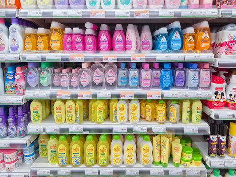 ​Neatly organized supermarket shelves stocked with colorful baby toiletries, including shampoo, body wash, and oil. parenting concepts