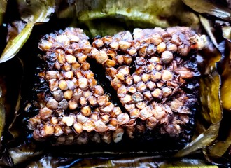 Grilled bee larvae in banana leaf, Thai northern style food.
