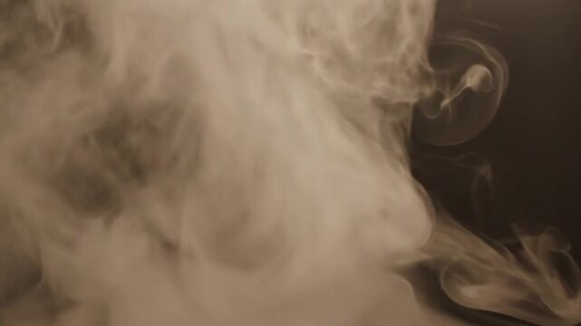 Smoke envelops a vehicle with a camera lens visible inside, captured in a close-up view