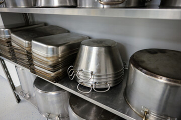 Details with stainless steel kitchen pots, pans and utensils in a professional canteen or hospital...