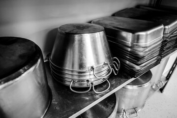 Details with stainless steel kitchen pots, pans and utensils in a professional canteen or hospital...