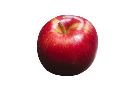 Fresh red apple sits on a white background while showing its shiny surface and smooth skin around midday