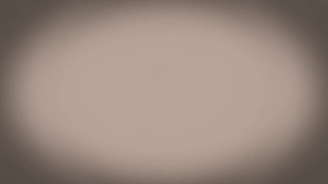 Blurry oval-shaped light spot on a dark background with a gradient effect.