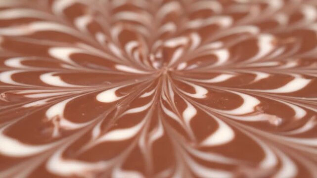 Close-up of a swirling marbled pattern of brown and white