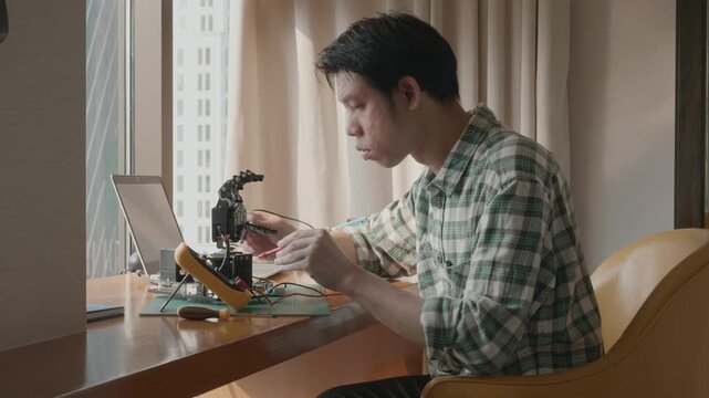 A focused individual is engaged in a robotics project at a sleek workstation, showcasing the intersection of technology and creativity. The modern environment enhances the innovative atmosphere.