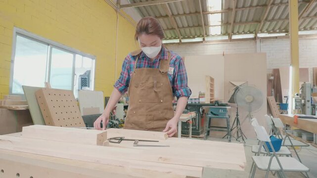 A skilled artisan works diligently on a wooden project in a well-equipped workshop, showcasing craftsmanship and dedication. Tools and materials surround her, emphasizing the intricacies of woodworkin