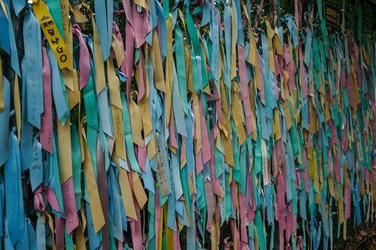 Prayer ribbons tied to a chain link fence, symbolizing hope for reunification between North and South Korea, inside a tourist area of the Korean DMZ in Paju, Gyeonggi-do, South Korea 