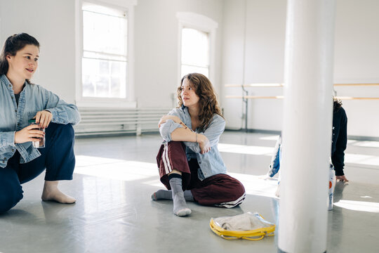Women conversing during dance studio rehearsal break