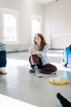Young woman smiling relaxed during dance studio break