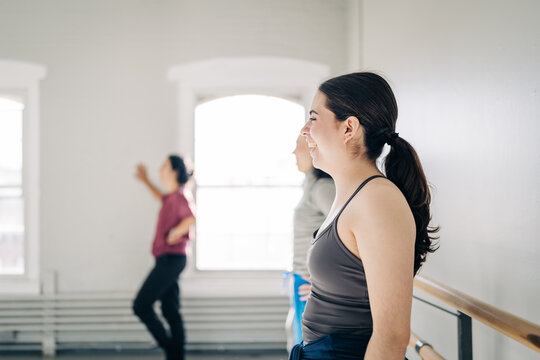 Woman smiling in ballet class enjoying hobby