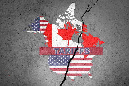 Canada and USA flags map painted on the concrete wall with word TARIFFS. Duty, trade, customs and tariffs war