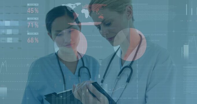 Animation of financial graphs and data over happy diverse female doctors making notes