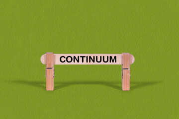 Fototapeta premium Continuum symbol. Wooden stick anchored by Clothespins, Cool Green Background. Business and Continuum concept with copy space