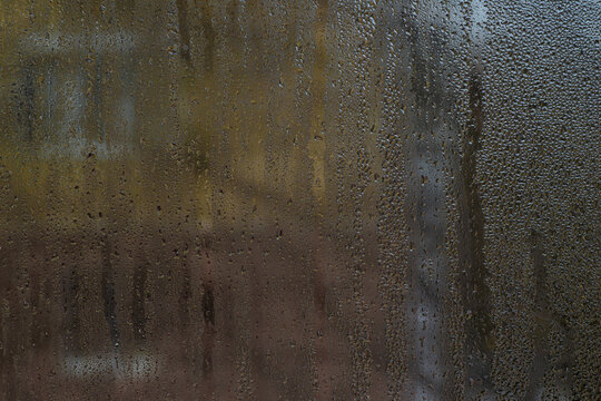 Slow-growing condensation droplets pattern interior glass like morning dew. abstract with glass background.