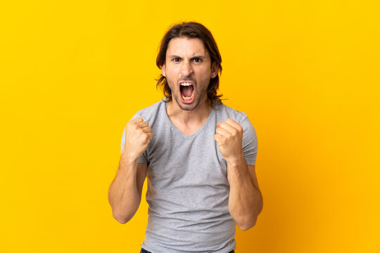 Young handsome man isolated on yellow background frustrated by a bad situation