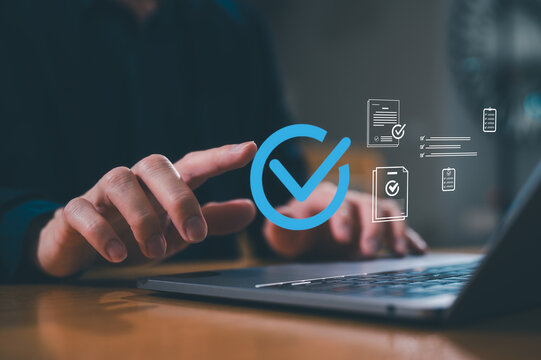Businessman use computer laptop review electronic files, utilizing intelligent management system to validate records and streamline final approvals, Digital document workflow and quality assurance