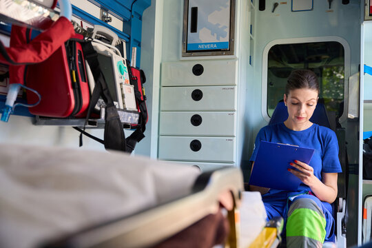 Emergency female medic preparing incident report