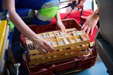 Female paramedic preparing medical kit inside ambulance © Svitlana