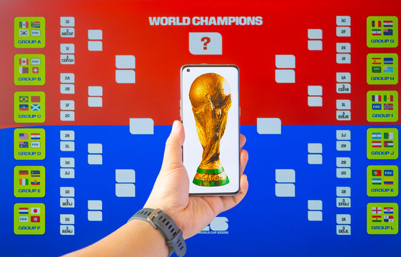 Zhongshan China-January 25 2026: Mobile with a FIFA World Cup Trophy photo in front of World Cup Bracket.