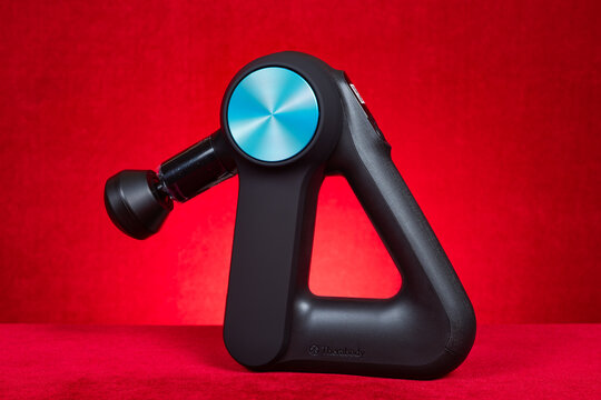 ZHONGSHAN China-January 29 2026: THERAGUN massage gun on red at horizontal composition.