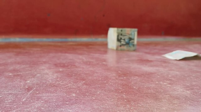House miniature model made with kuwaiti dinar (kwd) kuwait currency bank notes fall due to wind. House damage, insurance, home loan and increase housing price concept. Closeup side view.