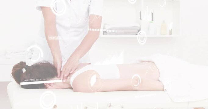 Mature therapist positioning behind client locating tight muscles for relieving stress in therapy